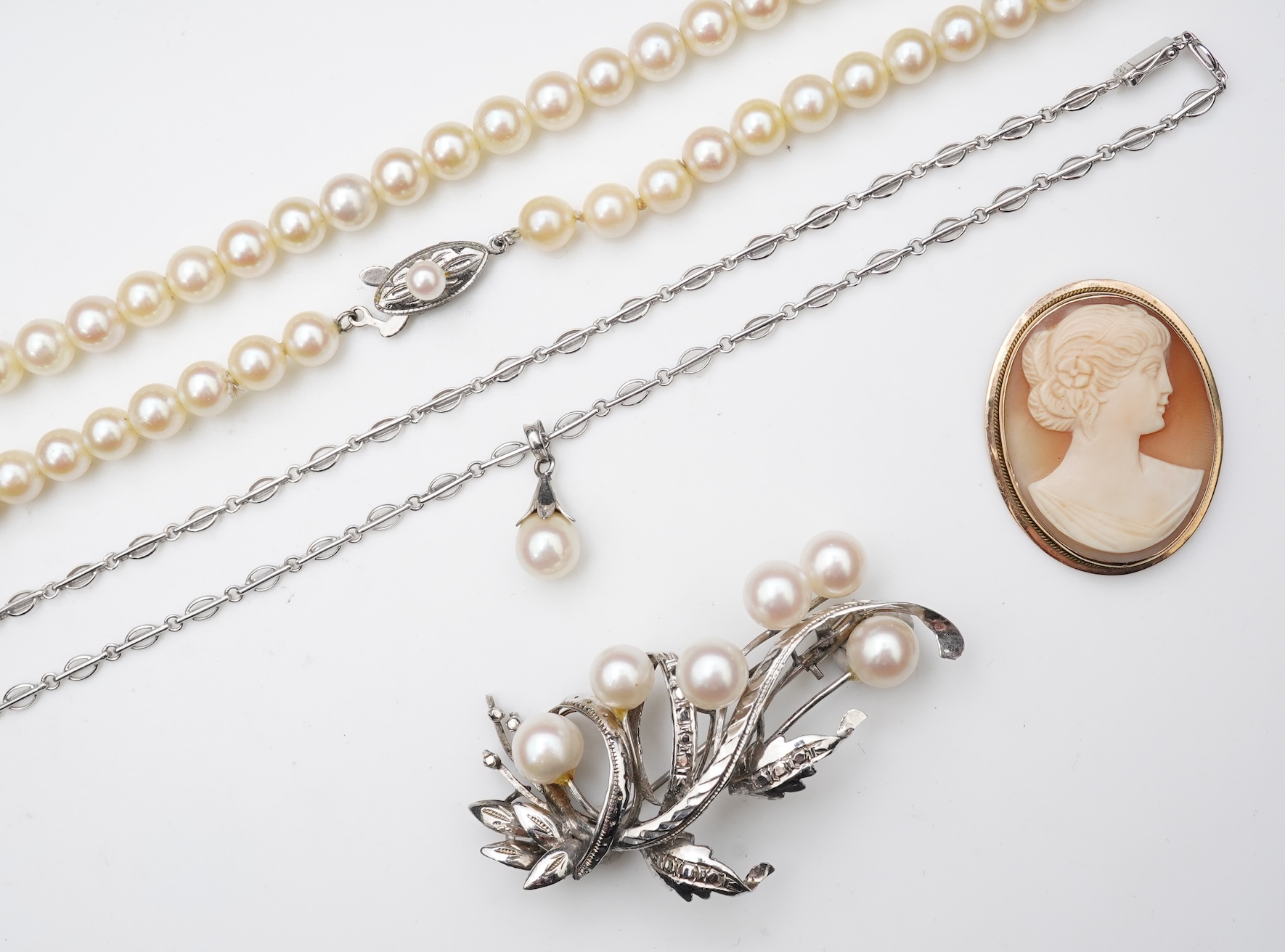 A collection of cultured pearl jewels and a cameo pendant